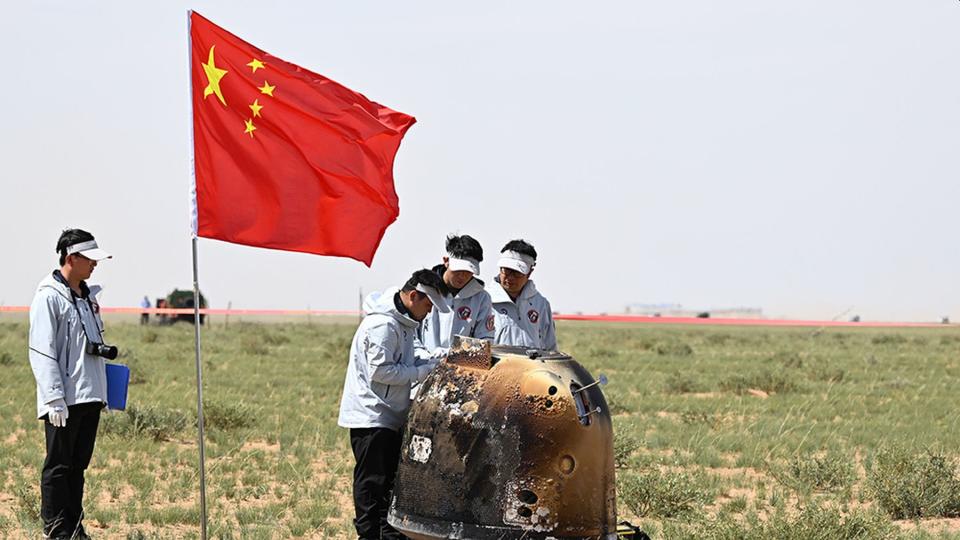 China Aerospace Administration technicians inspect the sample capsule CNSA