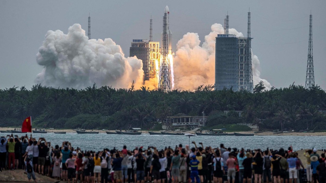 Dozens of people watch from the shore the launch of the Long March-5B Y2 rocket from the Wenchang Space Launch Center in Hainan, China.  April 29, 2021.