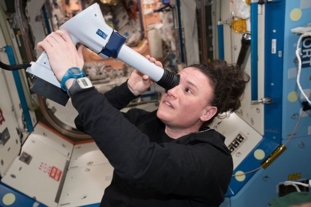 Astronaut Serena Onion checks her eyes on the International Space Station