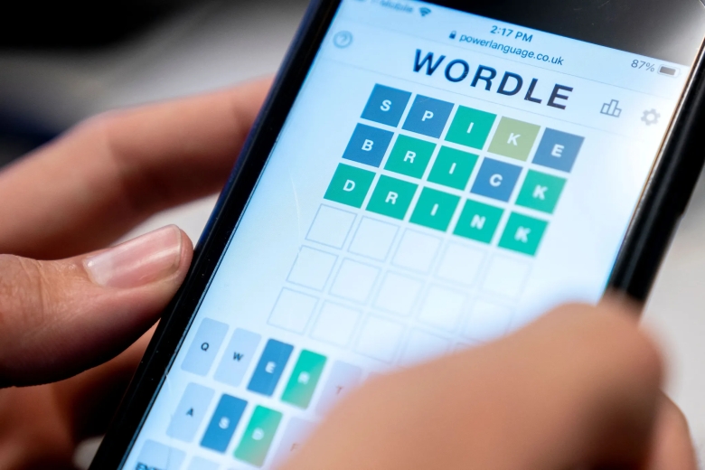 This photo illustration shows a person playing a word game online 
