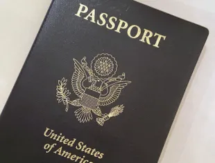 In this May 25, 2021 photo, the cover of a US passport is in Washington.  (AP Photo/Eileen Putman)