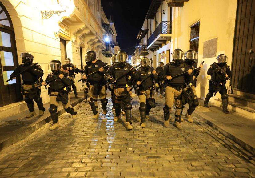 Agents in full protective gear prevented protesters from approaching the main entrance to La Fortaleza.