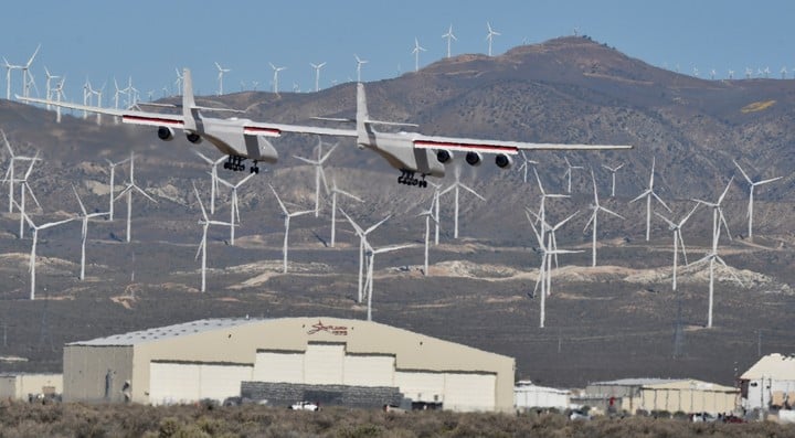 The jewel of Paul Allen and his company Stratolaunch Systems flies near the windmill complex in Mojave, California.