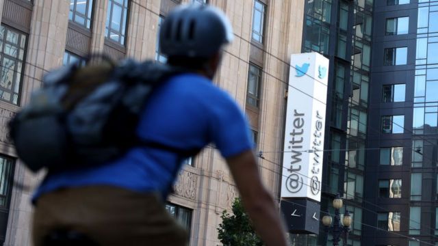 A cyclist passes by the Twitter office in California