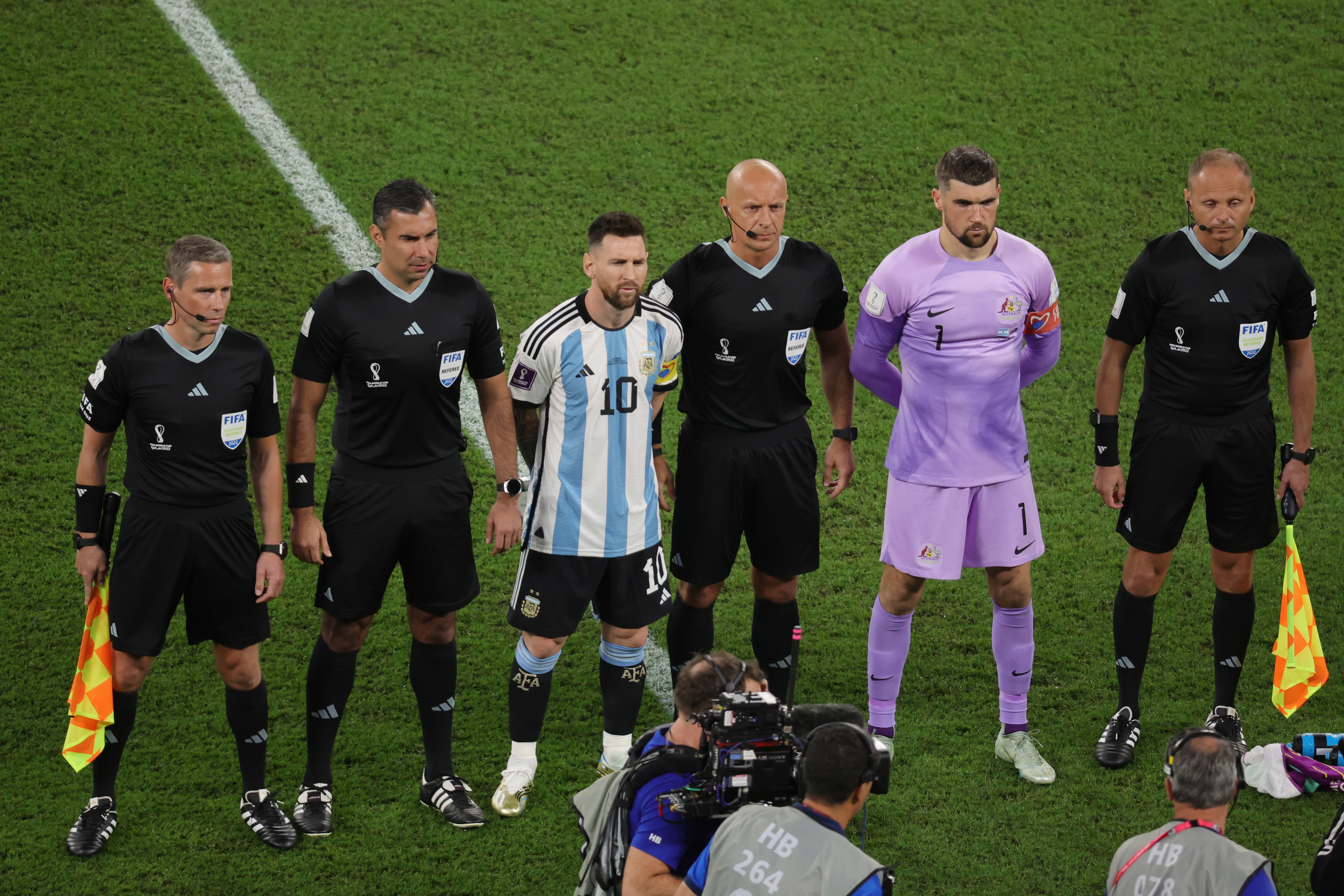 Referee Mario Escobar and Lionel Messi