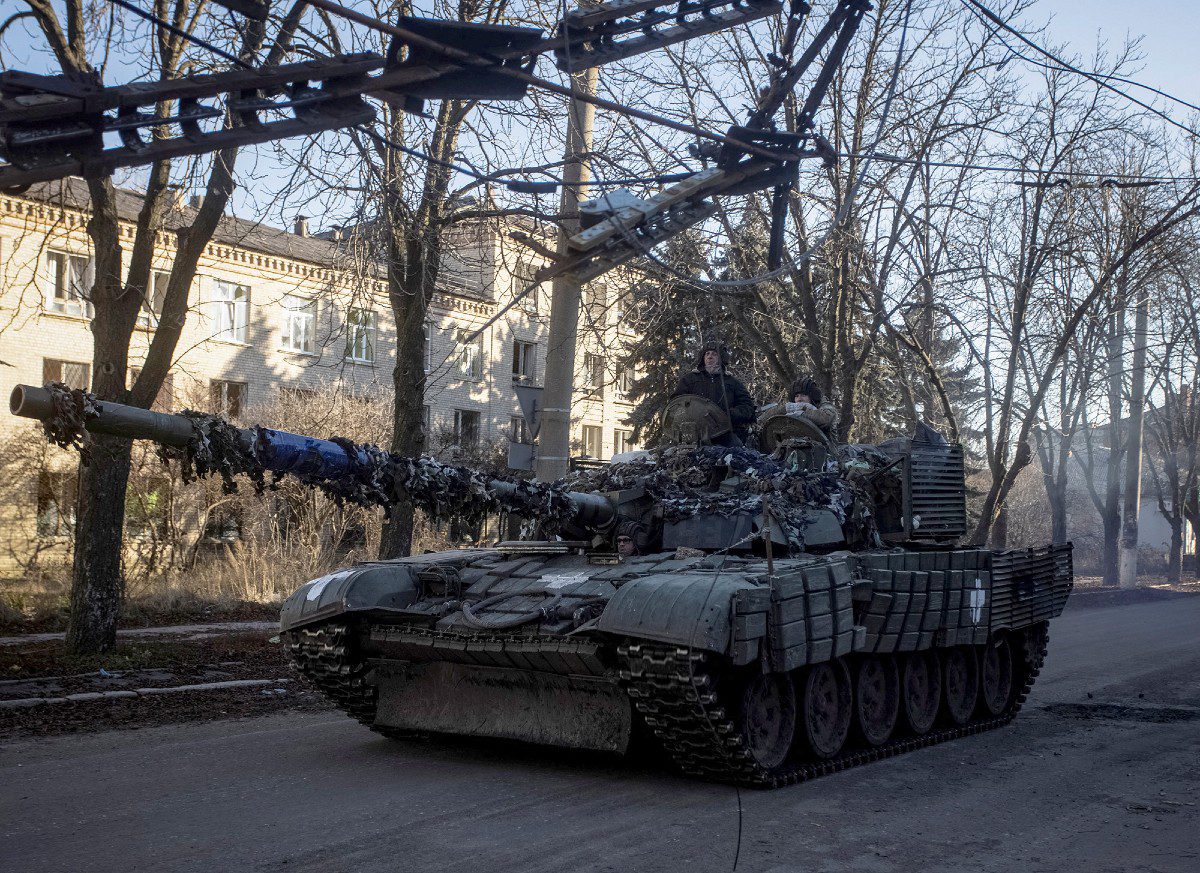 Ukrainian soldiers ride on top of a tank in Bakhmut, in Donetsk region, Ukraine, on December 5. (Yevhen Titov/Reuters) 