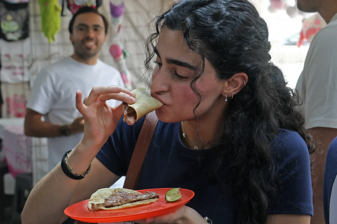 A diner enjoys one of the famous tacos at a Mexico City restaurant. (Photo: Silvana Flores/AFP/Getty Images)